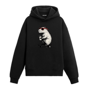 Kırmızı gözlüklü, elinde kahveyle kaykay üstünde duran kapibara figürlü Colermi hoodie.