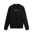 Siyah sweatshirt üzerinde göğüs kısmında altın tonlarında yazılmış “thank you” ifadesi bulunan minimal tasarım.
