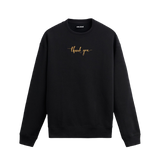Siyah sweatshirt üzerinde göğüs kısmında altın tonlarında yazılmış “thank you” ifadesi bulunan minimal tasarım.
